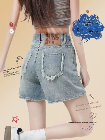 Back view of high-waisted raw-edge denim shorts in faded blue on a walking model