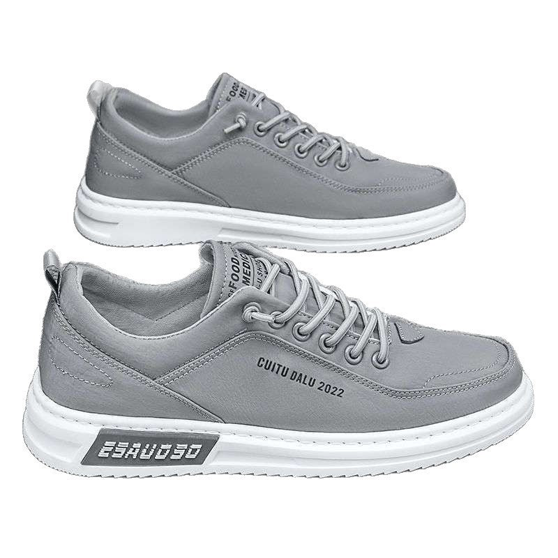 Pair of gray canvas lace-up sneakers with white rubber sole and heel tab on a white background