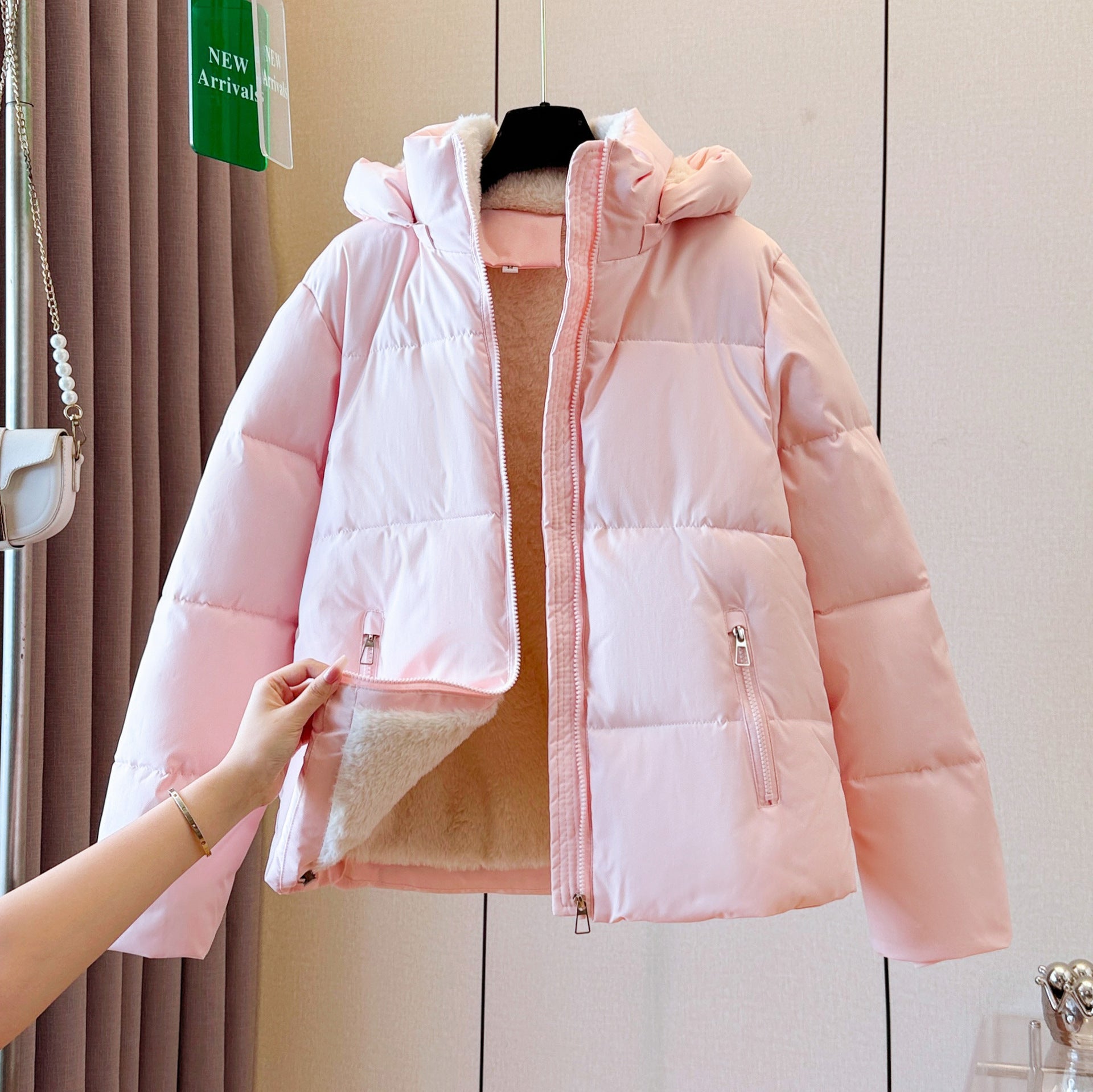 Fleece lined hooded puffer jacket with a rounded quilted silhouette and full zip