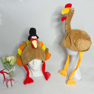 Two fleece turkey hats on white mannequin heads, a pilgrim hat style with red legs beside a long neck style with yellow legs