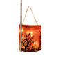 Orange party bucket bag with a spooky tree night scene lit through the fabric