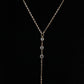Close up of three round clear rhinestones in prong settings on a fine gold tone chain