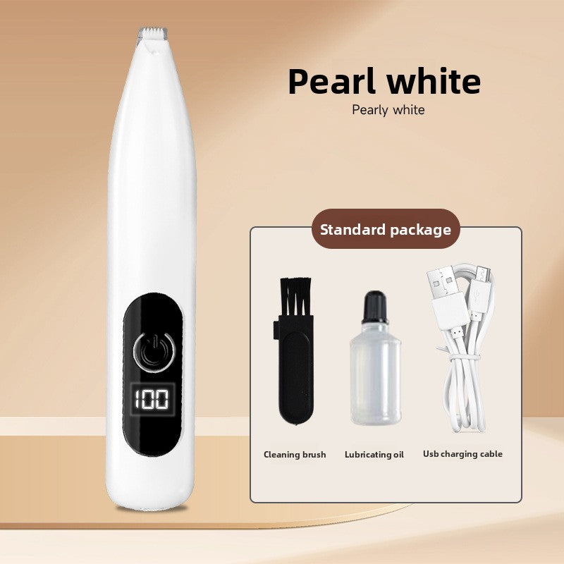 Pearl white pet paw trimmer beside the maker standard package of brush, oil bottle and USB cable