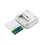 Kitchen timer back open showing the battery compartment with two AAA batteries and the cover