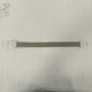 Single elastic quick release tourniquet band closed with its white snap buckle on a plain background