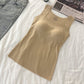 Nude beige seamless nylon square neck tank top, flat lay on white bedding with jeans, size M option photo