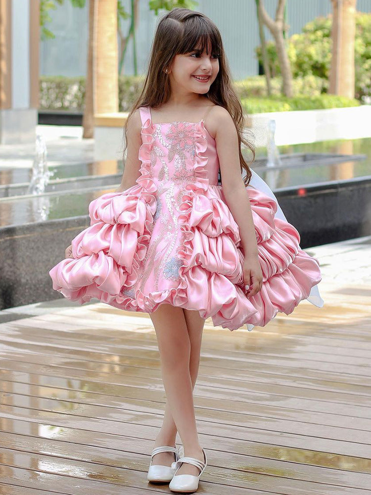 Girls' pink princess dress styled with tights and flats