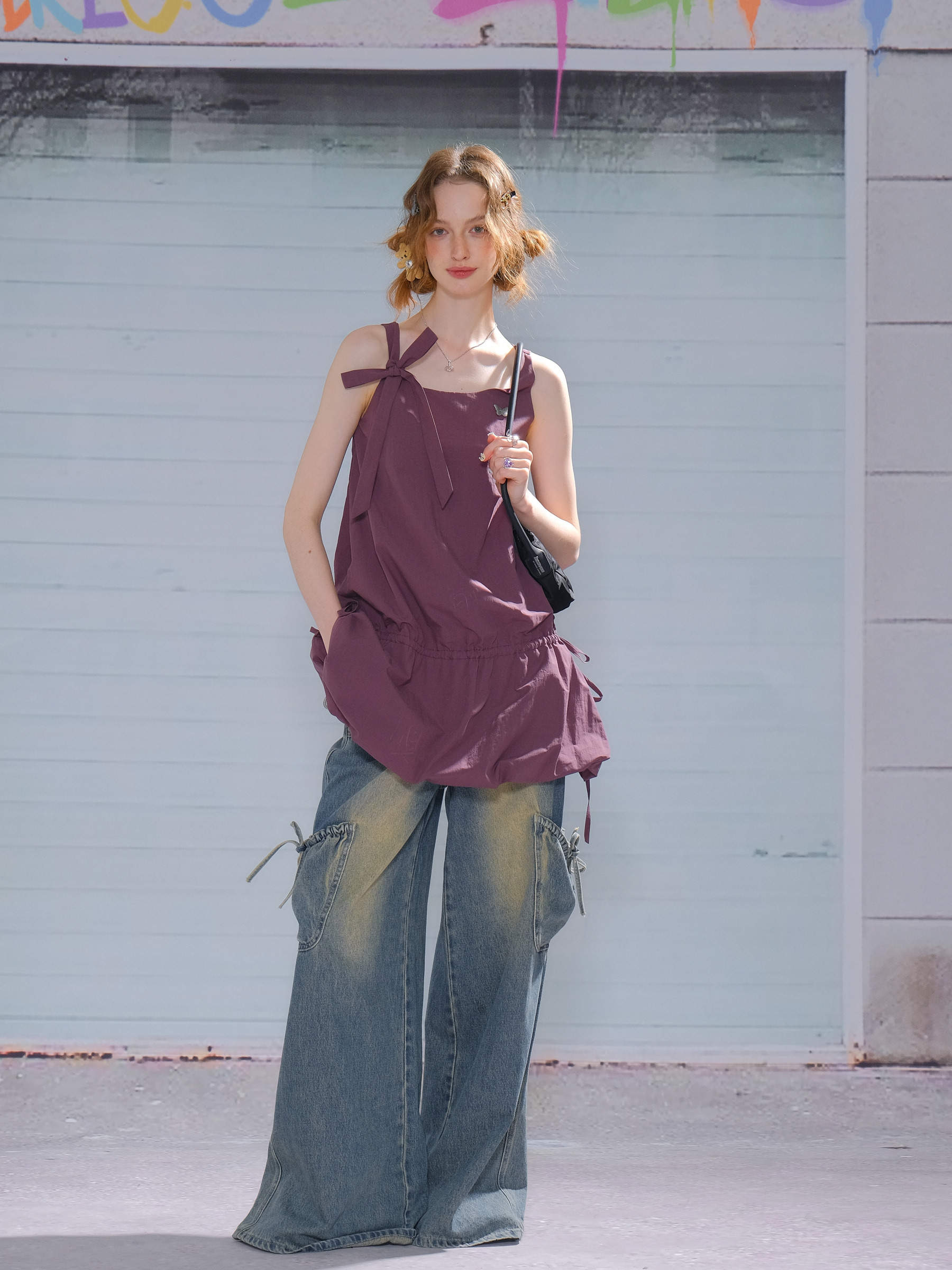 Side angle of cami dress walking in a garden setting