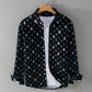 Black ground shirt jacket with cool toned frayed patch prints on a hanger