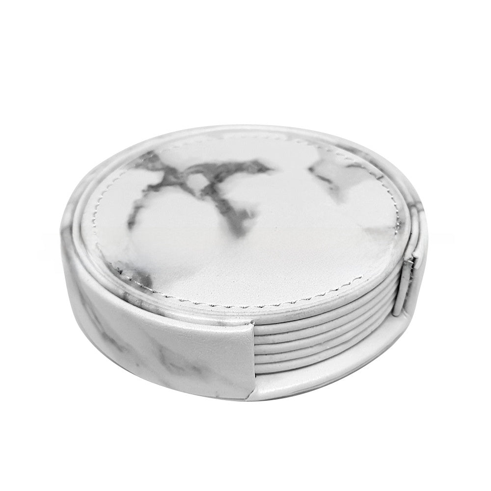 White marble PU leather round coasters fanned out beside a holder