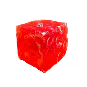 Large red squishy cube pressed inward showing the soft dimpled slow rebound surface