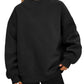 Woman in a black oversized mock neck sweatshirt with black leggings, front view