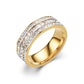 Gold tone band ring with three rows of clear rectangular and round stones on a white background