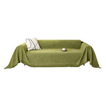 Chenille herringbone sofa cover draped over a sofa in a solid color