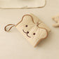 Quilted cotton changing pad unfolded with the bear-face flap and carry loop