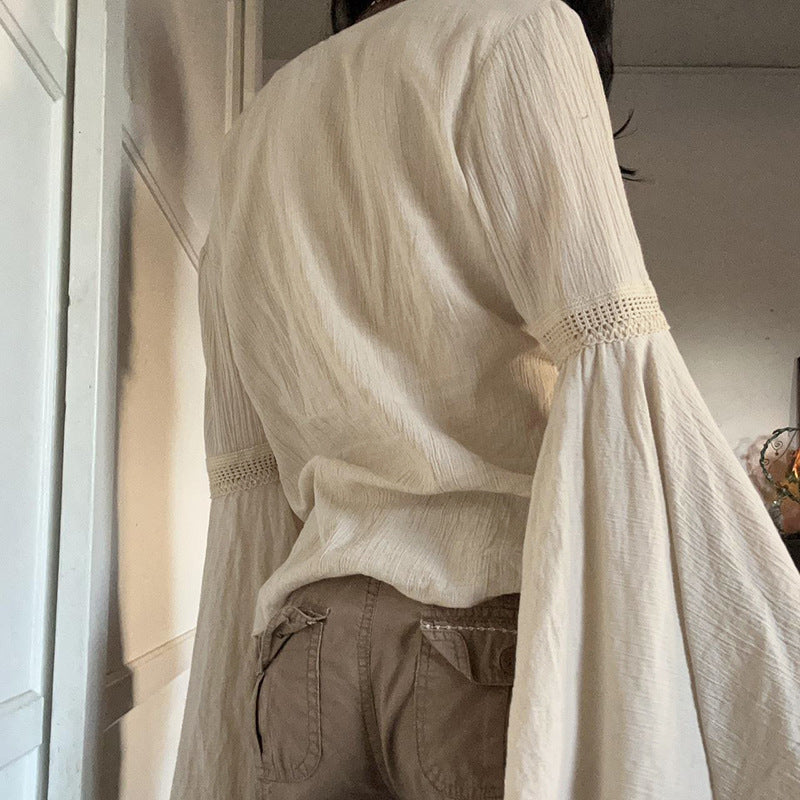 Back view on the model showing the plain round neckline and the crinkle fabric falling from the shoulders