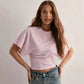 Styled view of the soft drape casual top layered over trousers with the relaxed batwing sleeve