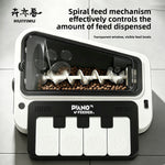Black and white piano shaped pet feeder with transparent hopper showing a spiral feed mechanism and kibble