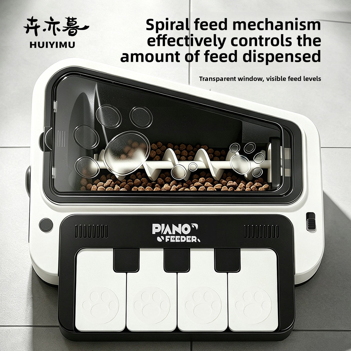 Black and white piano shaped pet feeder with transparent hopper showing a spiral feed mechanism and kibble