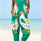 Size 2XL option: Emerald green overalls with a large white chicken print, cuffed legs and pockets on a beach