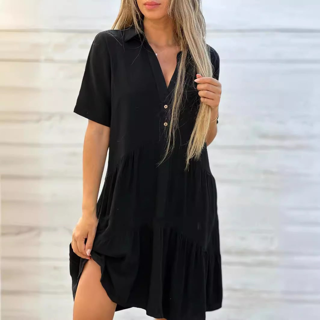 Navy blue short sleeve cotton and linen tiered shirt dress with a lapel collar over a two button front placket