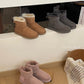 Chestnut, gray and pink ankle boots with shearling cuffs lined up on a white shelf, Gray Thin Sole option, size 36