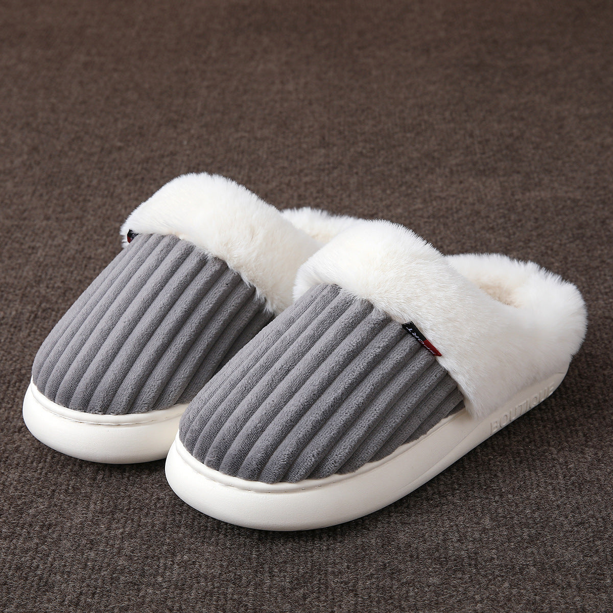 Plush lined slip on slippers with a thick white platform sole and an open heel