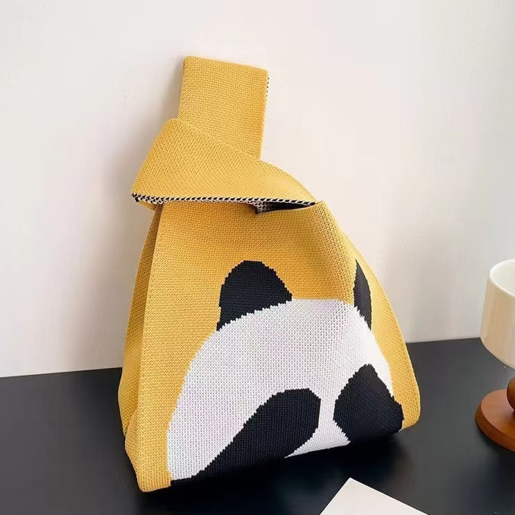 Knitted pattern wrist bag with a soft unstructured body and open top