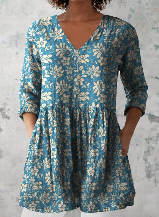 Floral print V neck tunic top with hidden side seam pockets at the hip