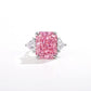 Pink radiant cut simulated diamond between two clear trillion side stones, plain white background