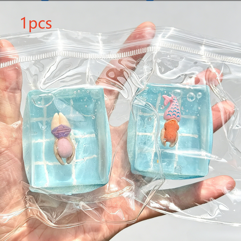 Clear squishy toy with a swimmer and a moulded bubble in blue water