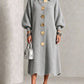 Gray long ribbed knit dress with polo collar, balloon sleeves and large gold-tone buttons on a model