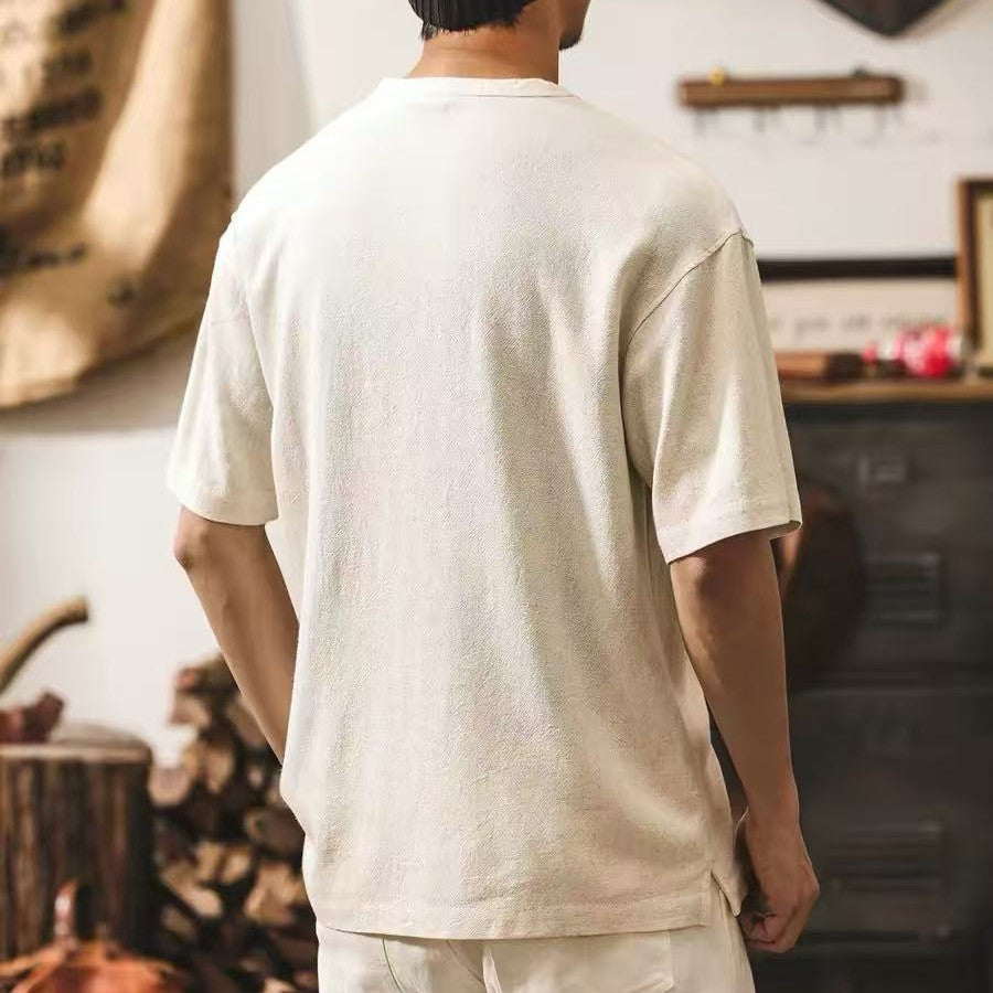 Back view of a man wearing the roomy natural white cotton pet pouch t-shirt