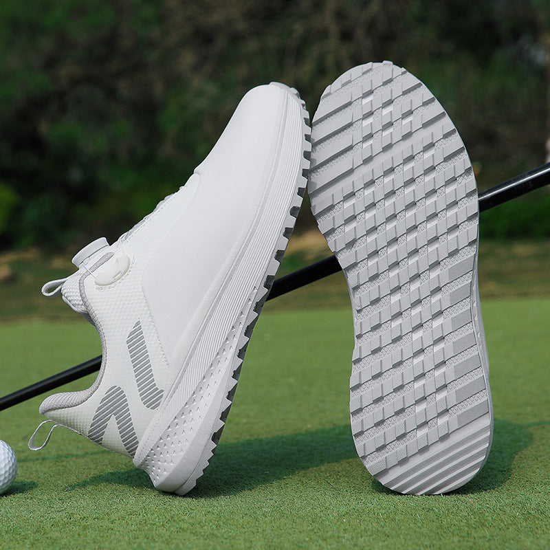 White low top golf shoe with a twist dial closure and a nubbed spikeless rubber outsole