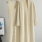 Apricot two piece ribbed knit set showing the buttoned dress beside the long open cardigan