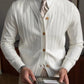 White ribbed knit V-neck cardigan on a model, angled studio view with striped tie