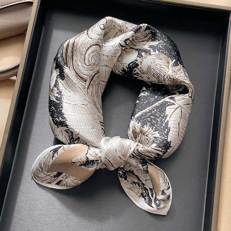 Cream and black baroque scroll printed square scarf with a satin sheen and hemmed edges, shown displayed