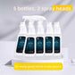 Five white bottles of oil stain cleaner with two spray heads on a pale podium, promotional photo