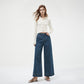 Hand resting in the front pocket of high-rise wide-leg jeans