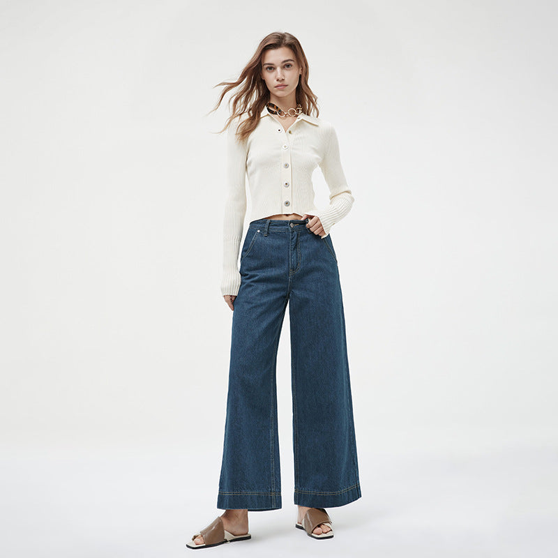 Hand resting in the front pocket of high-rise wide-leg jeans