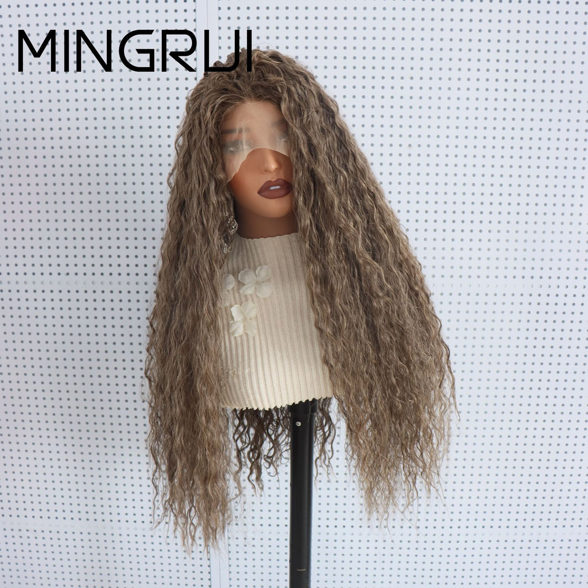 Side view of a long curly brown synthetic lace front wig with light highlights on a mannequin