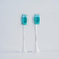 Two white brush heads with teal bristles and clear caps, option image for the White LED Brush Head 2pcs option