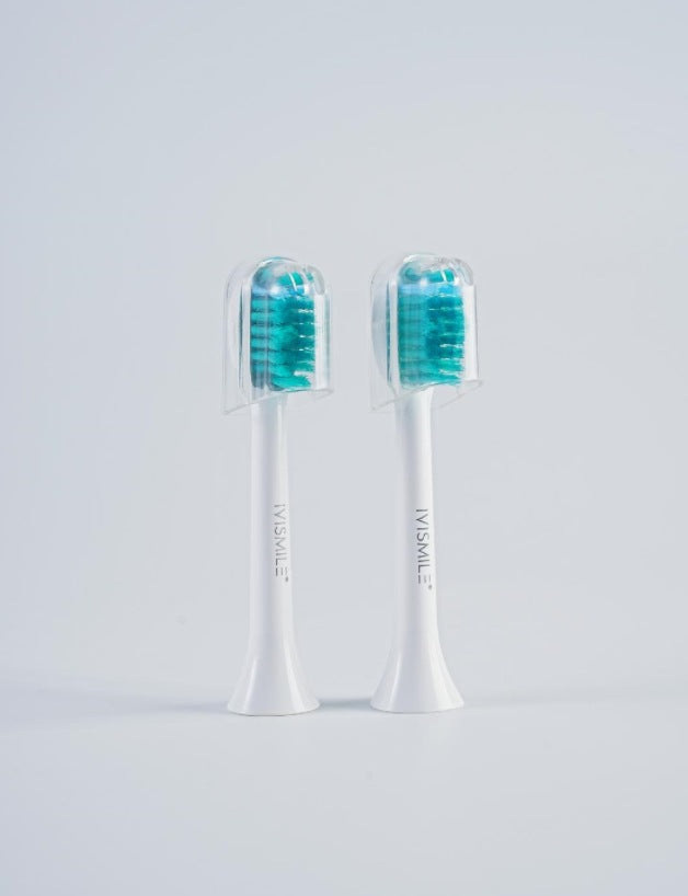 Two white brush heads with teal bristles and clear caps, option image for the White LED Brush Head 2pcs option
