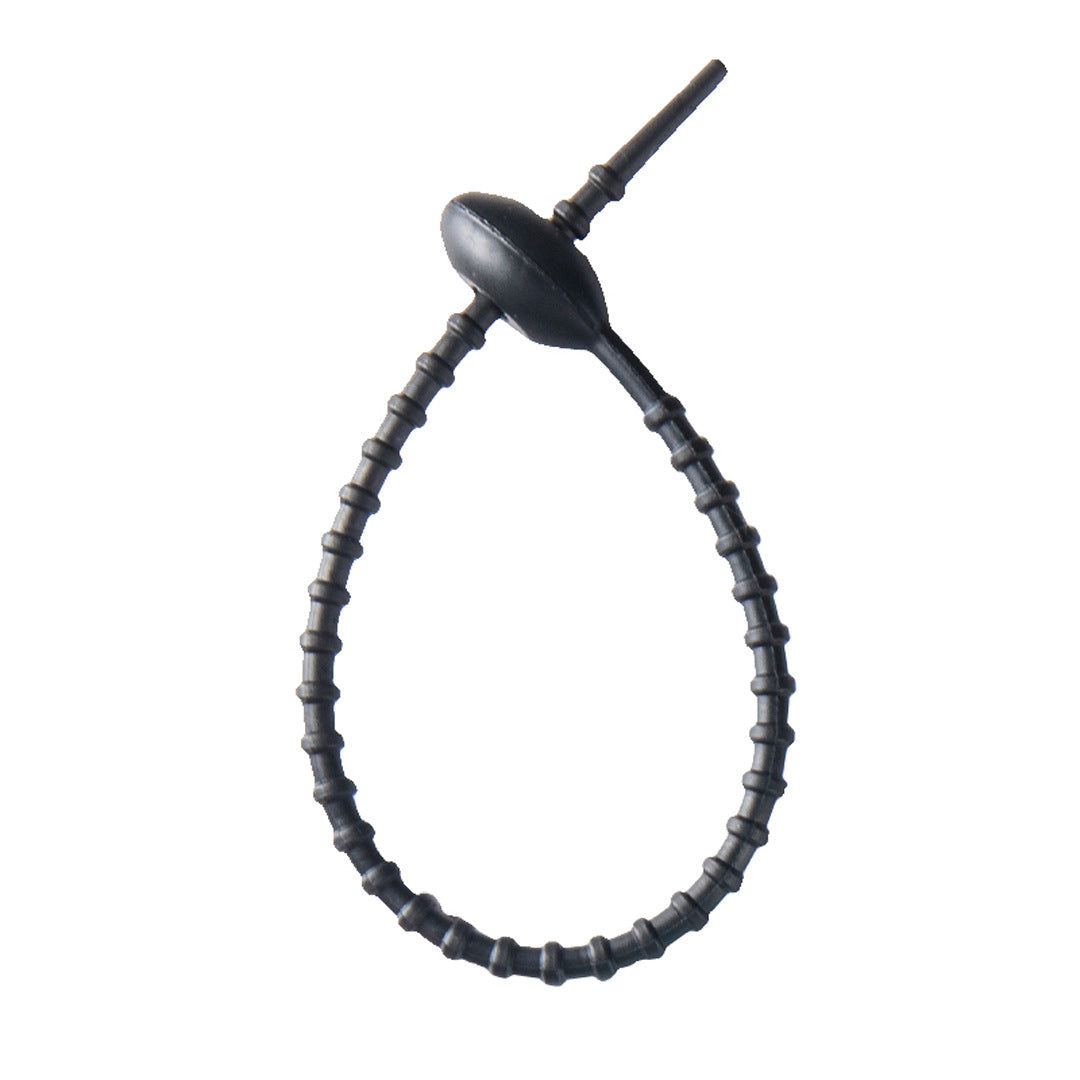 Tadpole silicone tie looped around a wrist to show how flexible the strap is