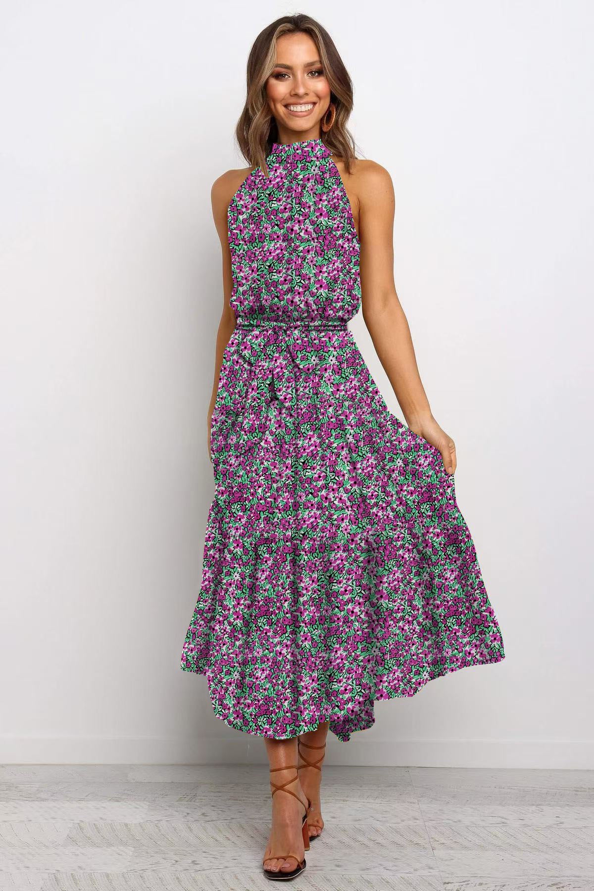 Red boho floral halter neck sleeveless tiered swing maxi dress worn by a model