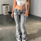 Washed light grey flare denim front view with a double button yoke waist and angled flap pockets