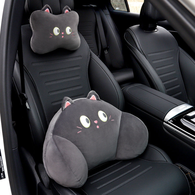 Black cat headrest pillow on the seat headrest and black cat lumbar pillow on a black car seat