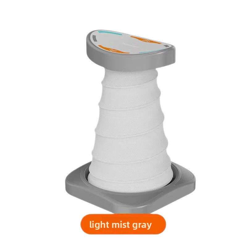 Light mist gray and white push-up support stand with a ribbed elastic column, curved top pad and gray base plate