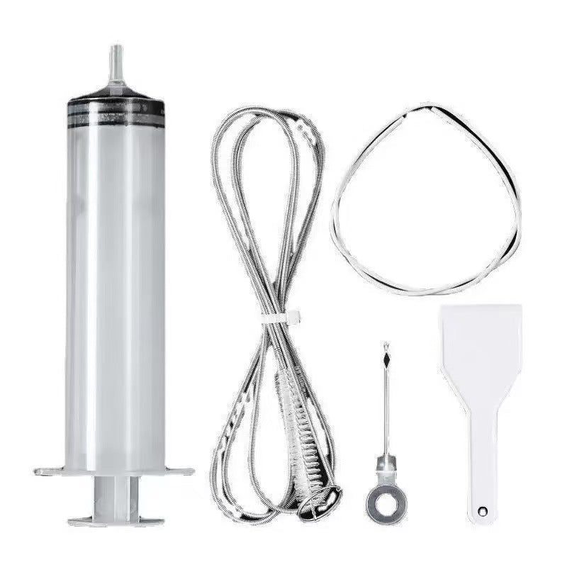 Syringe, folded wire brush, loop and white scraper laid out on a white background