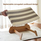 Hand lifting the striped corrugated cardboard pad off its brown base to show the replaceable design